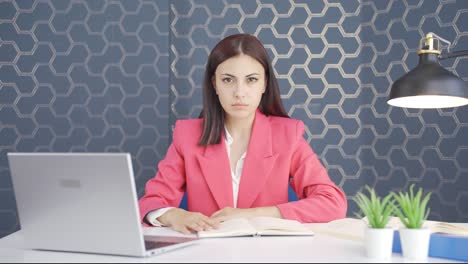 Young-business-woman-saying-stop-to-camera.