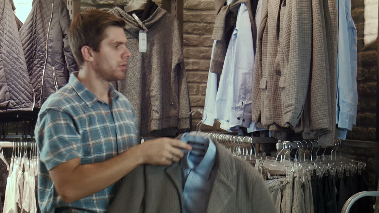 Man browsing clothing in a retail store
