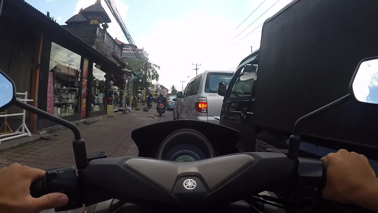 Road view from a motorcycle in a busy Asian city