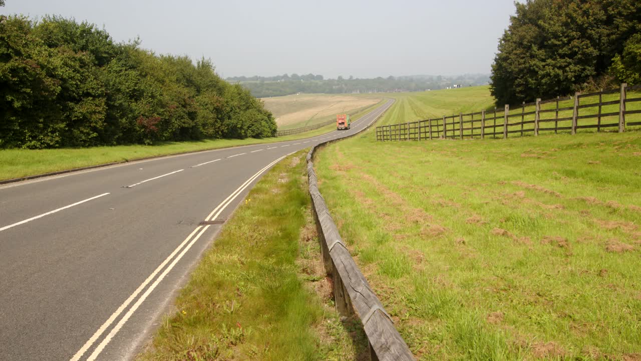 shot looking down Carsington water dam with the dam road and traffic