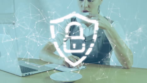 animation of shapes and padlock over caucasian businesswoman using laptop