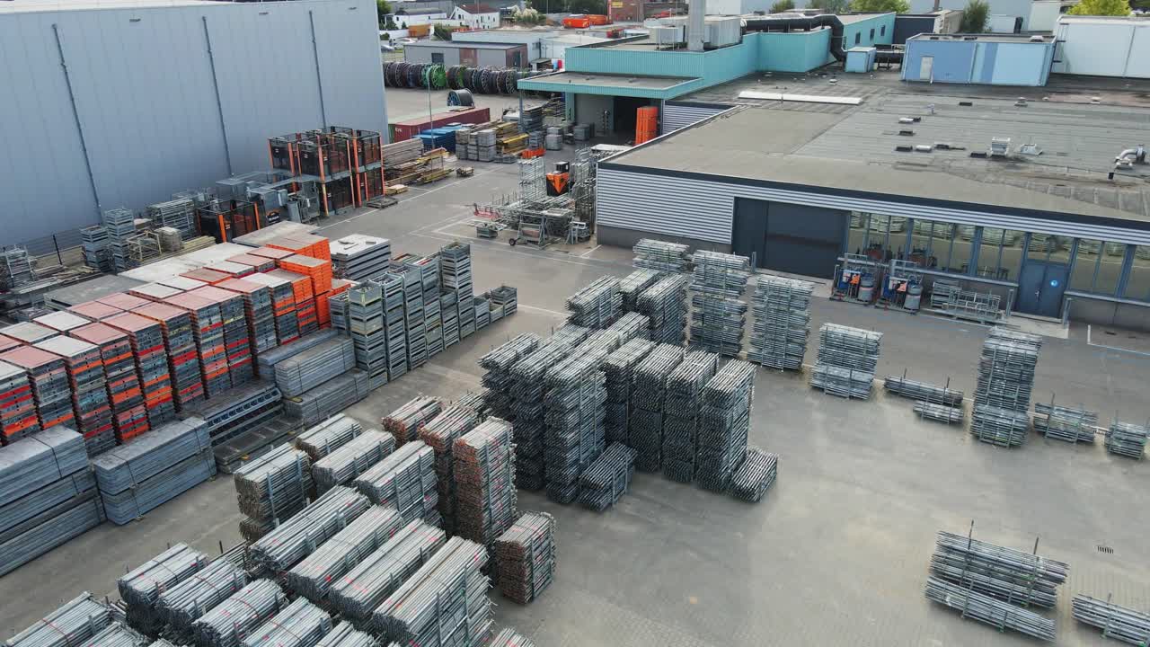 Beautiful aerial of an industrial storage yard with neatly organized stacks of construction materials of an industrial company on a sunny day