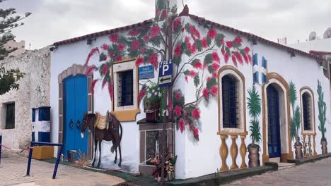 colorful corner house with hand painted walls in chersonissos, crete, greece