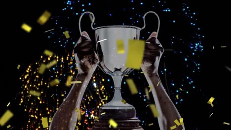 animation of confetti falling and fireworks over caucasian man holding silver cup