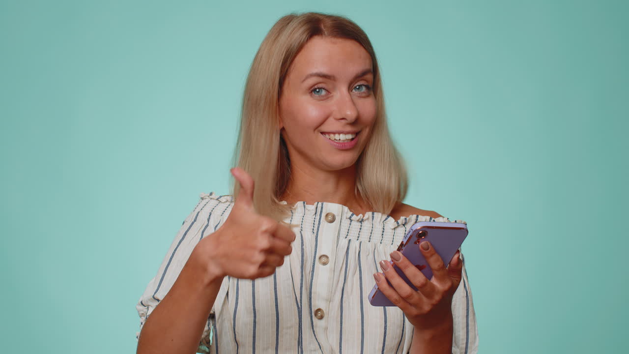 Tourist woman using smartphone show thumbs up like, positive feedback, recommends wifi connection 5G
