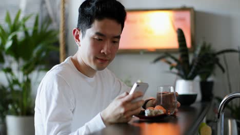 Man-drinking-water-while-using-mobile-phone-4k