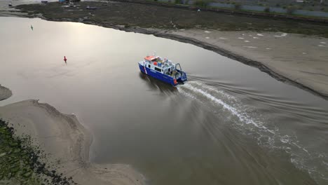 Fishing-Trawler-entering-port-at-dusk-on-the-River-Wyre-Estuary-Fleetwood-Lancashire-UK