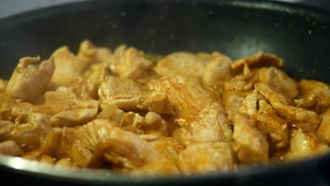 chicken cooking in a pan