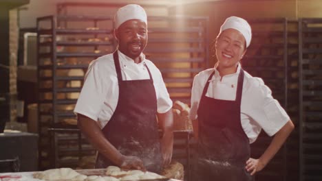 Animation-of-happy-diverse-male-and-female-bakers-looking-at-camera