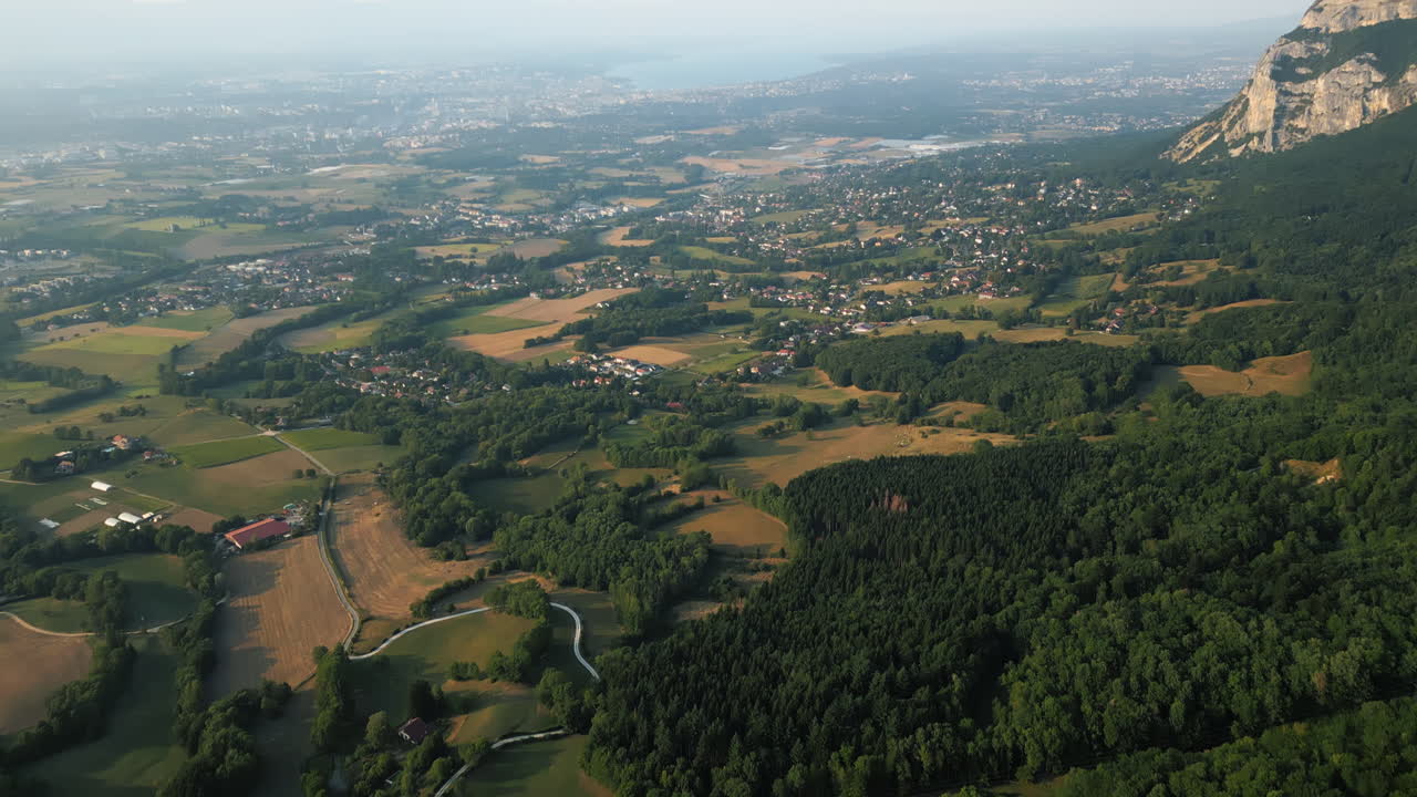 Reveal drone shot of Saleve, canton of Geneva and Lake of Geneva at sunset from France