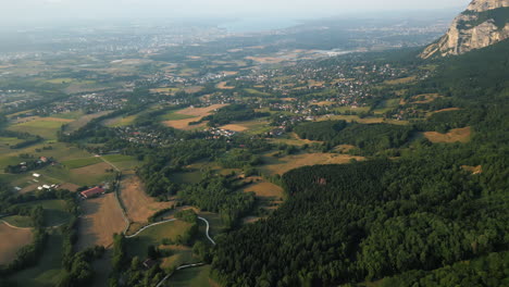 reveal drone shot of saleve, canton of geneva and lake of geneva at sunset from france