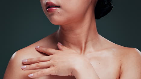 close-up portrait of a woman with a hand on her chest