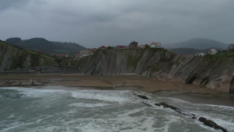 pan aerial acros itzurun playa en un día nublado tormentoso