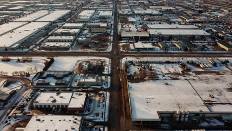 aerial revealing shot of an endless warehouse area in calgary in winter