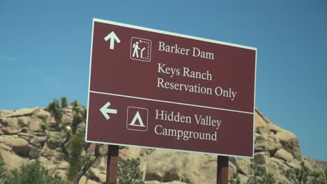 Road-Sign-in-Joshua-Tree-National-Park,-California-USA,-Driver's-POV