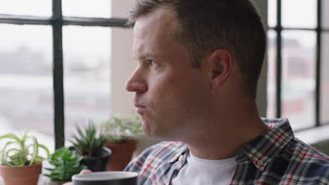 portrait-young-caucasian-man-drinking-coffee-at-home-enjoying-relaxed-morning-looking-out-window-planning-ahead-thinking-successful-male-relaxing-close-up