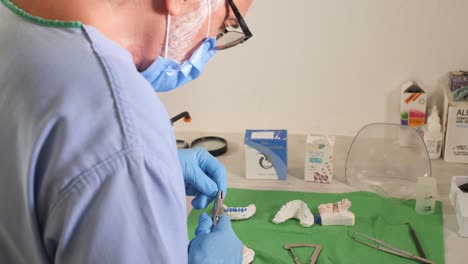 grizzled mexican dentist preparing and shaping cable for