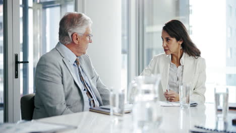 business meeting - two people discussing work at a table