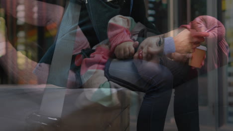 in school, child wearing colorful clothing resting on adult's lap, holding animation