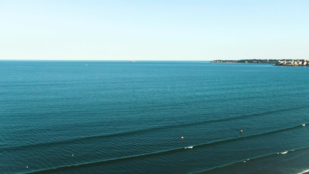 Calm, blue ocean water of Nahant Bay with sky horizon. Aerial view