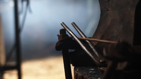 blacksmith ironworker grabs tools ready to work on metal in the workshop