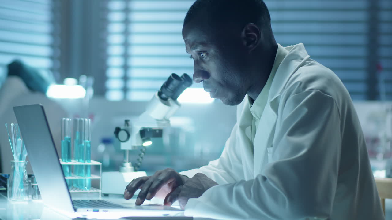 African American Lab Scientist Working on Laptop