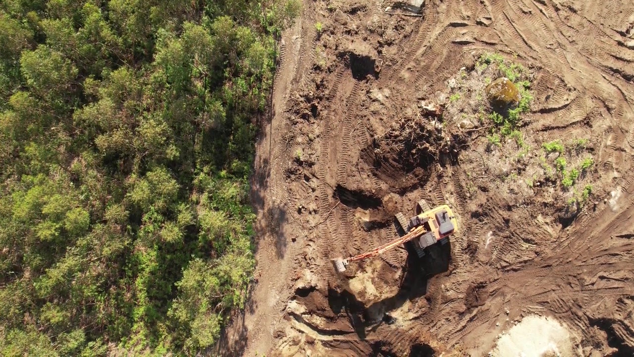 Excavator operating on a hillside from Above