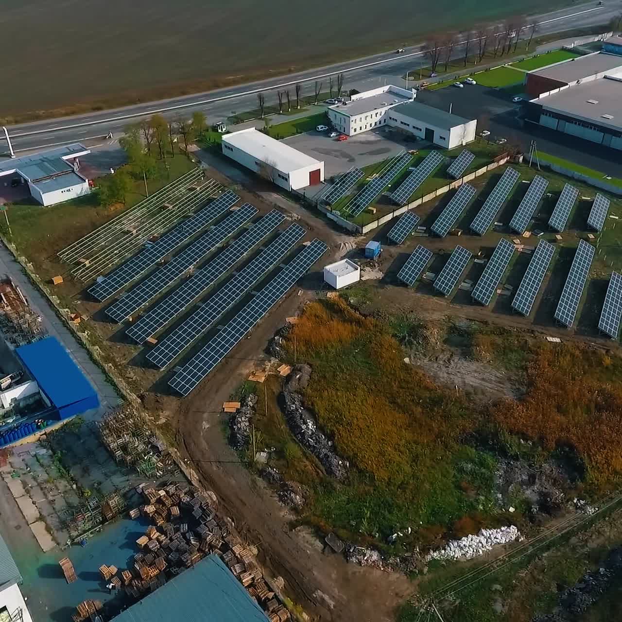 Solar panels with sunny sky above. Blue solar panels. Background of photovoltaic modules for renewable energy. View from above