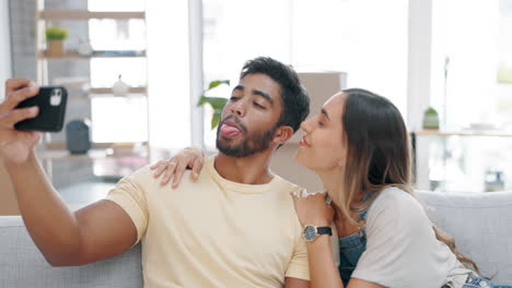 Selfie,-couple-kiss-and-peace-sign-in-new-home