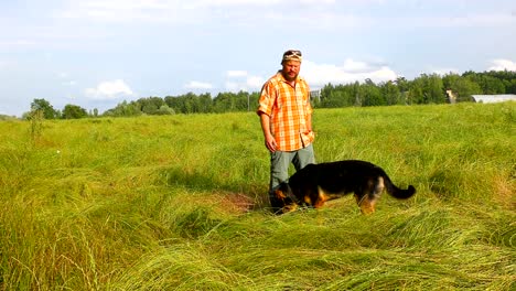 man with his dog at green grass field