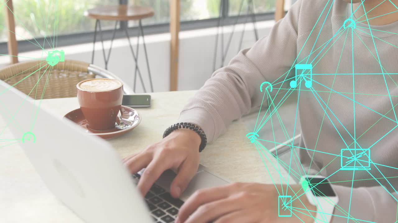 카페에서 노트북을 사용하는 이중 인종 남성 위에 회전하는 디지털 아이콘의 두 개의 글로브의 애니메이션