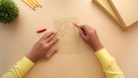 person correcting mistakes on paper with red pen