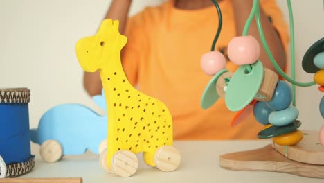 child playing with wooden toys