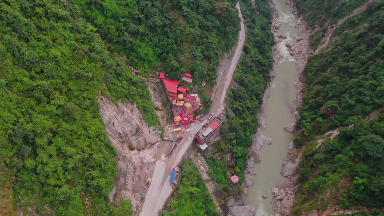 Aerial drone footage of the famous Siddhababa Temple in Tansen Palpa, Nepal, located on a scenic hillside with winding mountain roads and stunning natural surroundings