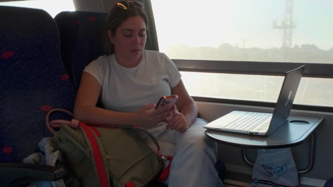 Everyday Life: Commuter Focused on Her Smartphone Screen