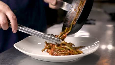 Plating-Freshly-Stewed-French-Green-Beans-In-A-Restaurant-Kitchen---close-up