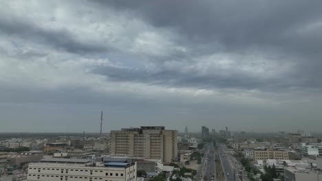 Aerial-drone-panning-shot-over-office-buildings-in-Korangi-industrial-area-in-Karachi,-Pakistan-on-a-cloudy-day