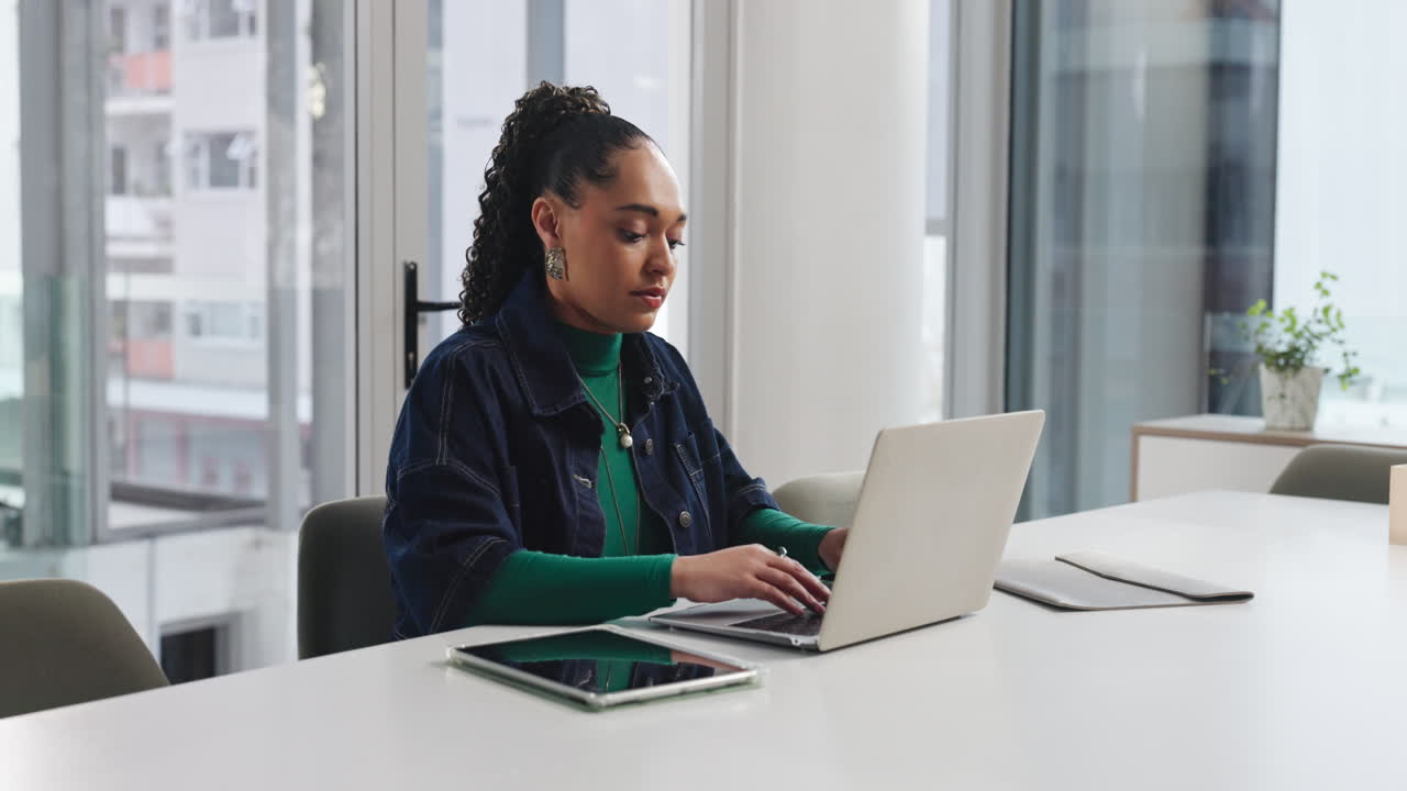 Woman working on a laptop in an office