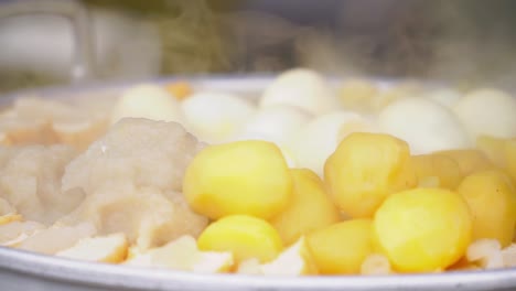 potatoes, tofu and eggs steaming in a steam pot