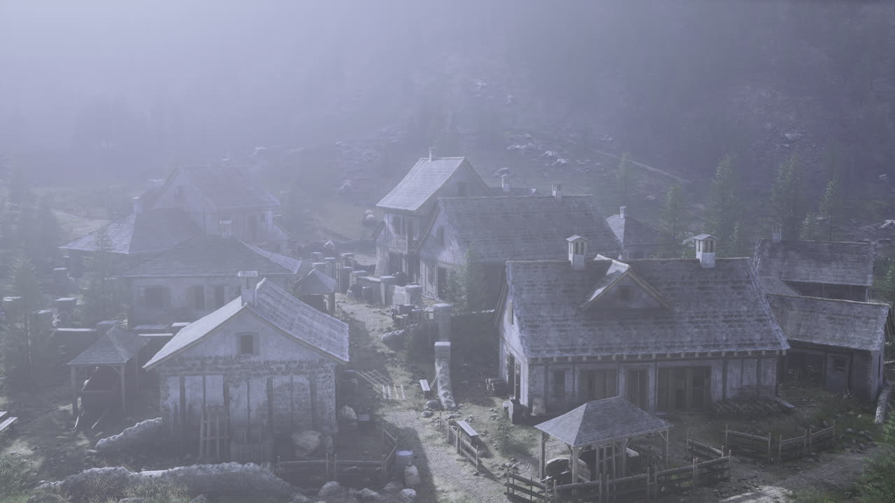 Foggy village with historic buildings in a mountainous region during morning