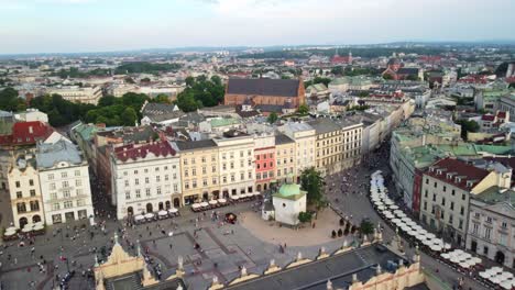 panoramic aerial view of the main market square of krakow old town, crowd of tourists gathered, sightseeing main market square