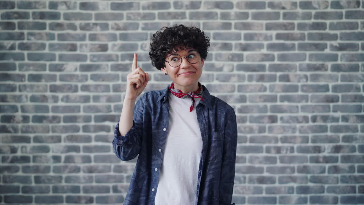 Woman Posing in Front of Brick Wall