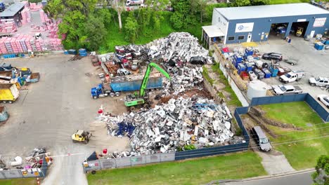 machines moving metal scrap in industrial yard