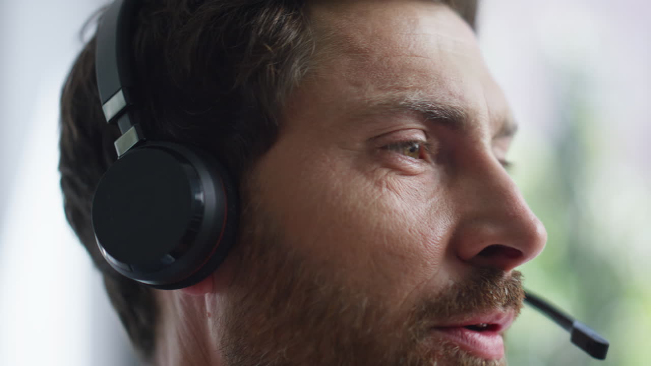 Closeup helpdesk operator talking headset providing customer support in office