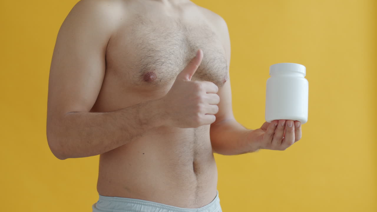 Man Holding a Supplement Bottle