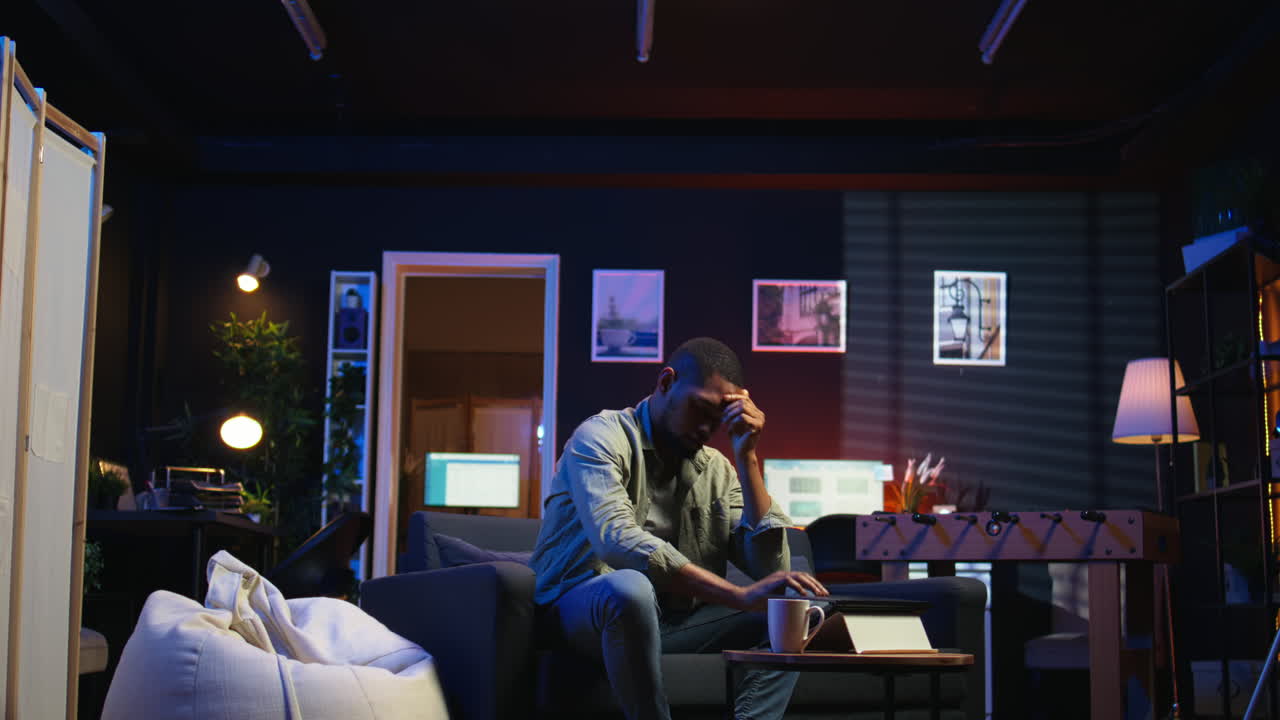 Vertical Video Tired black man failing some tasks and struggling to focus at home