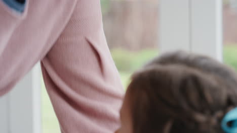 grandmother gently kissing little girl on forehead showing love for granddaughter proud granny feeling love for grandchild 4k