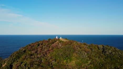 Drone-Flying-On-Tutukaka-Lighthouse-Headland-By-The-Coastal-Cliff-With-Splashing-Waves-In-North-Island,-New-Zealand