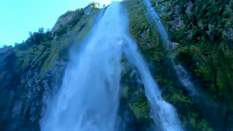 up close to beautiful waterfalls while cruising around milford sound in new zealand