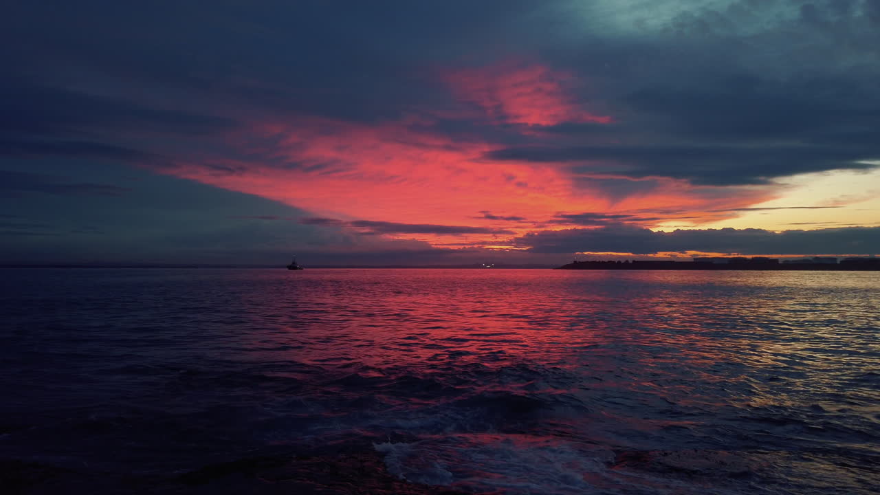 Burning red color lit up clouds over entrance to bay of Sydney, slow motion
